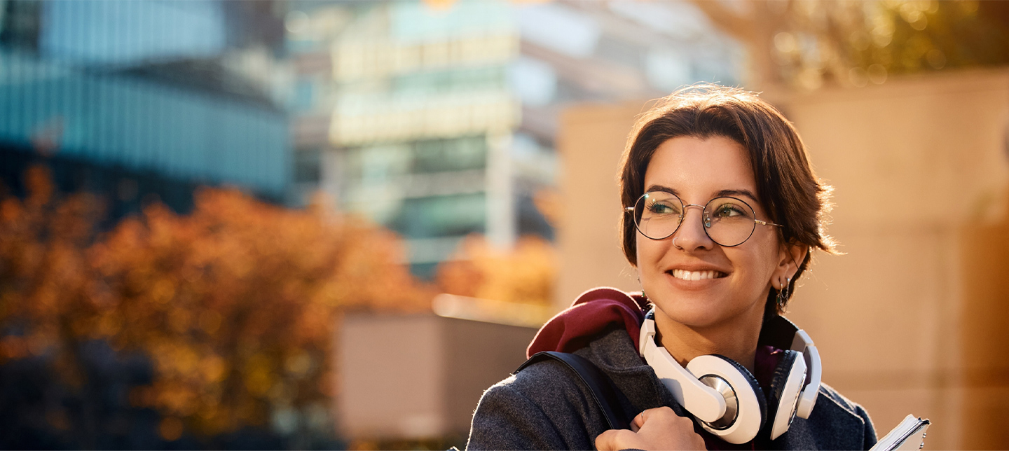 Female student outside happy headphones