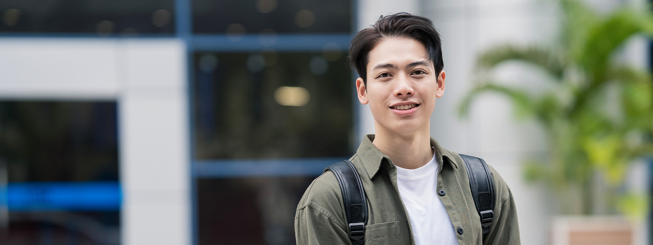 Male student holding laptop