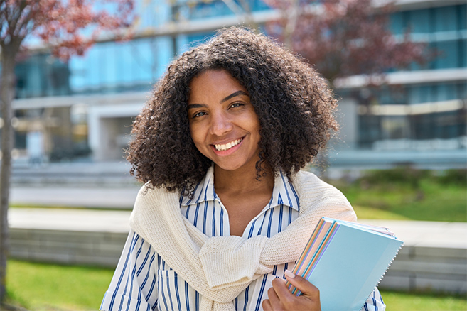 Student outside campus happy sunny